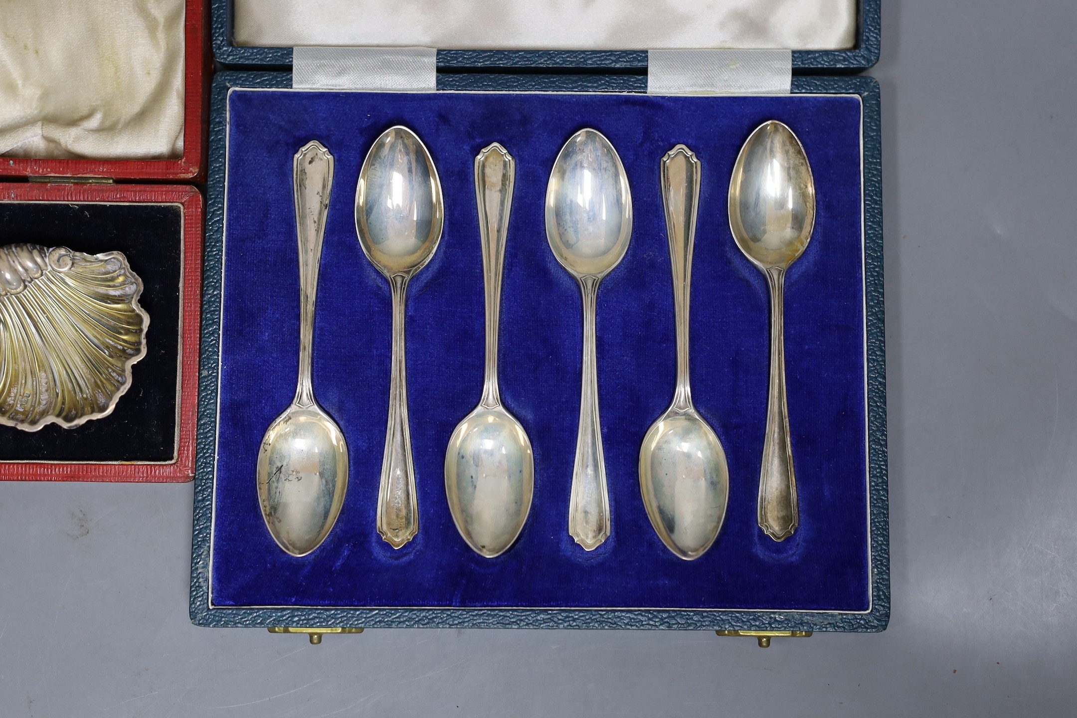A cased pair of Edwardian silver shell salts and matching spoons, Birmingham, 1903, 51mm and a cased set of six modern silver teaspoons.